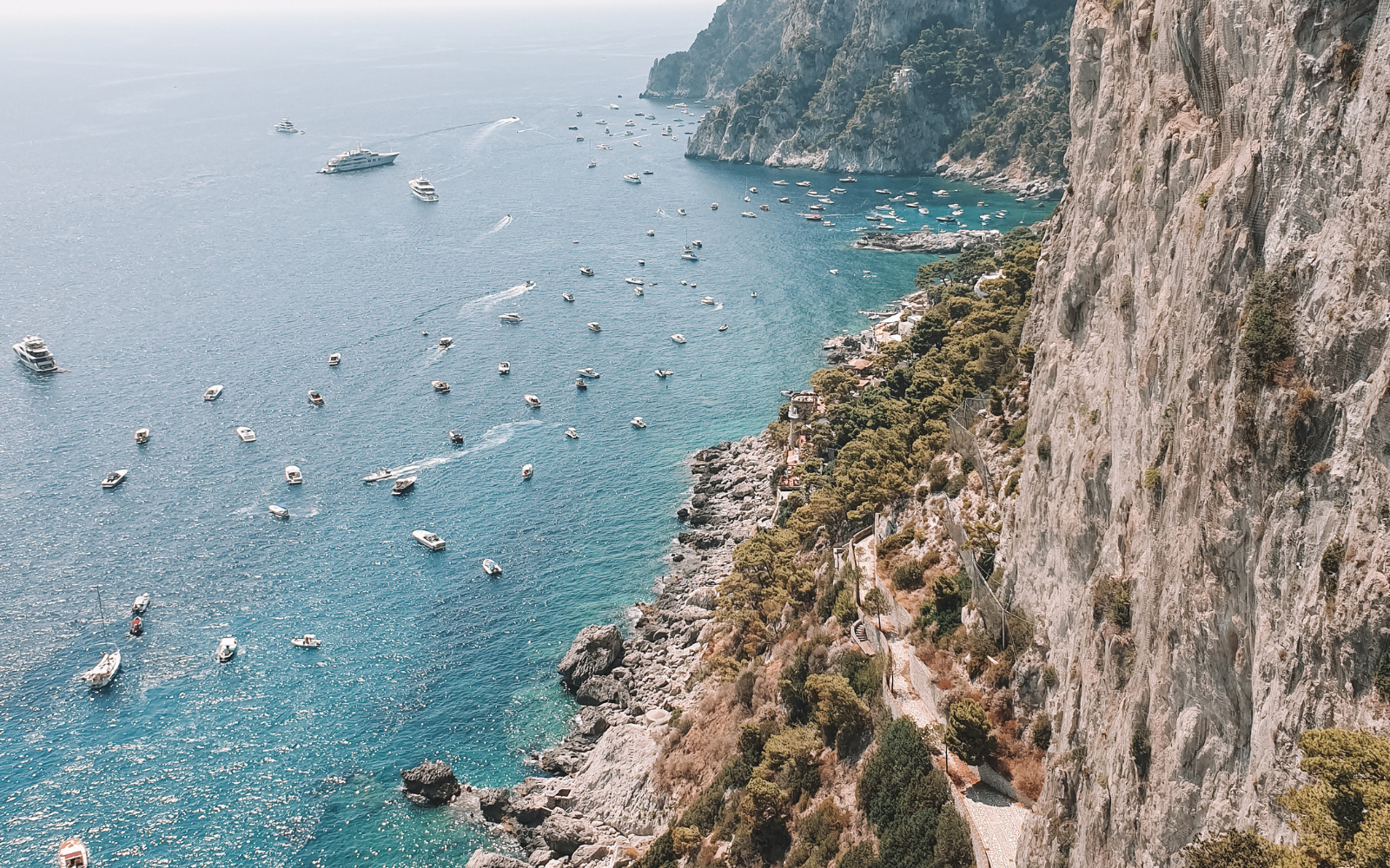 a group of boats floating on top of a large body of water.